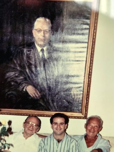 Ron Brien with family members beneath a portrait of Chief Justice Earl Warren